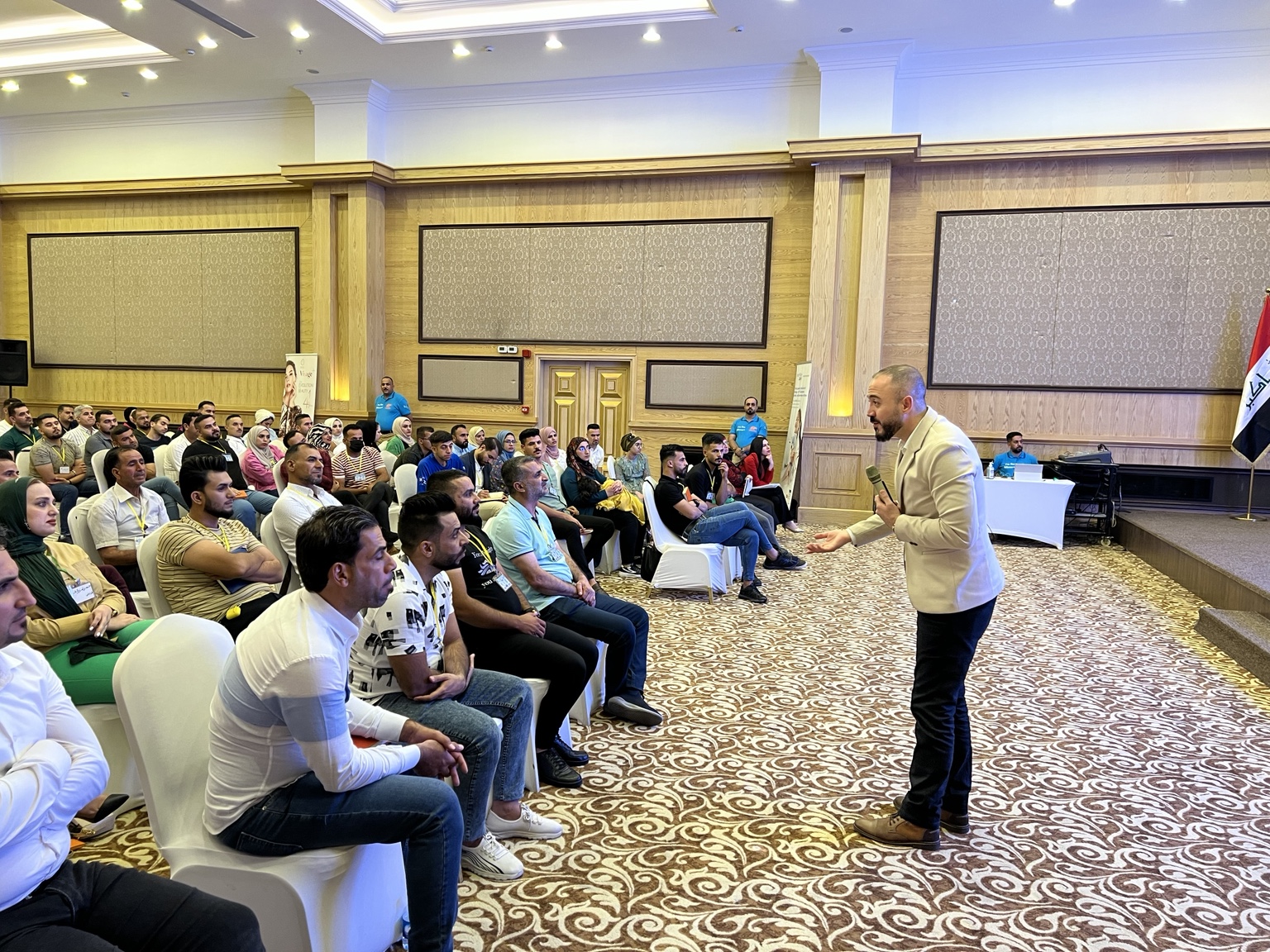 Wiam Abboud speaking with an audience in a training room